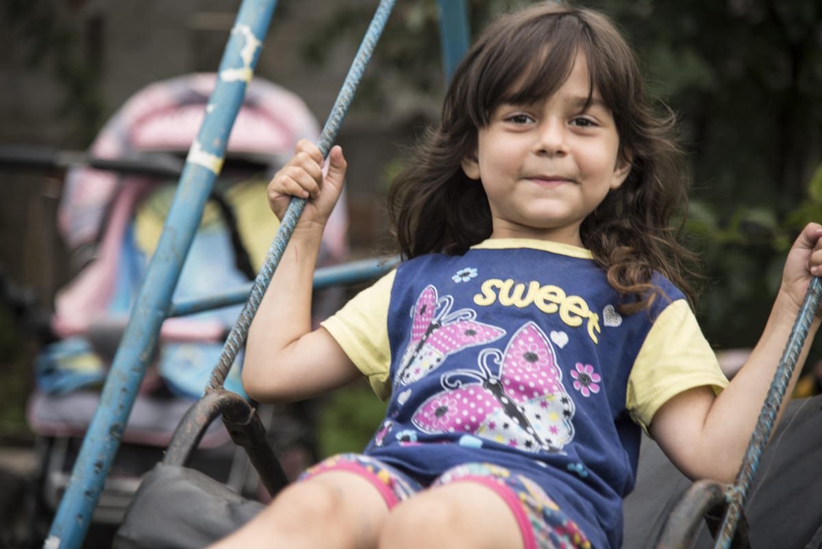 A child on a swing at an SOS Children's Village in Greece